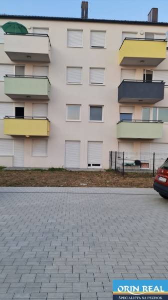 Apartment building on Nyárfa in Bratislava - Jarovce with a parking lot in the foreground.