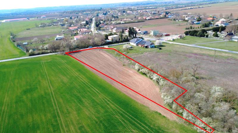 Aerial view of agricultural land in Ondrejovce surrounded by gardens and the village.