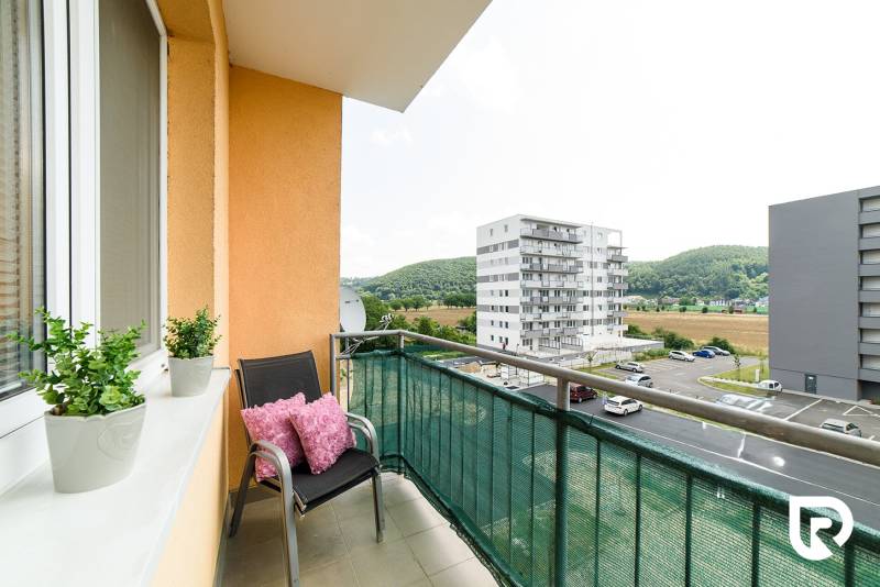 The balcony of a 2-room apartment on Armádna Street in Trenčín with a view of the surrounding buildings.