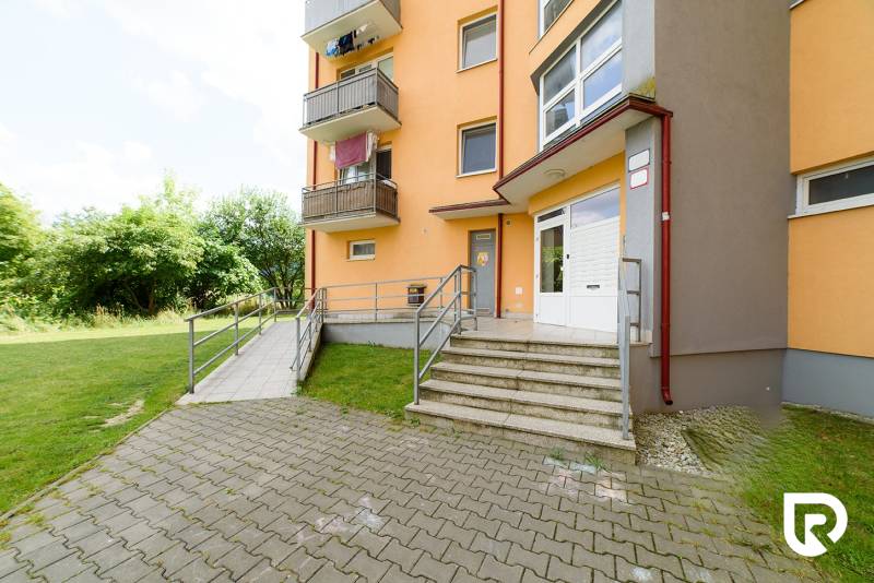 Apartment building on Armádna Street in Trenčín with access stairs and greenery.