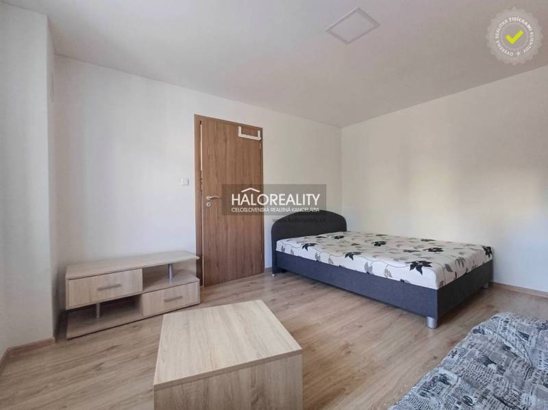 1-bedroom apartment with a bed and furniture on a floor with a wood decor.