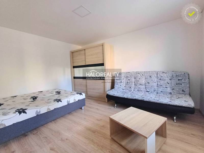 1-bedroom apartment with a bed, sofa, wardrobe, and table. Floor with wooden decor.