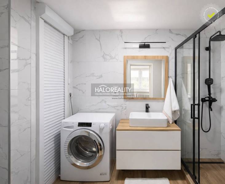 Bathroom with a washing machine, shower, sink, and floor with wood decor in a 4-room apartment.