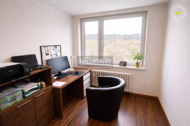A study in a 4-room apartment with a wooden decor floor and a large window.