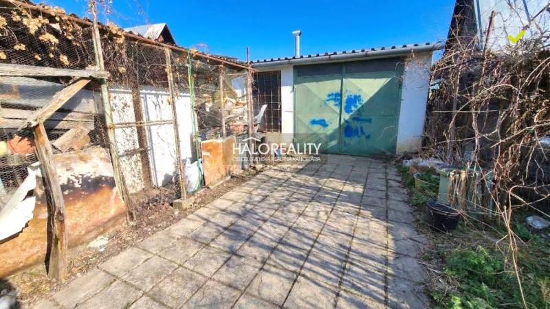 Outdoor area with a shed by the cottage in Poltár on a sunny yard.