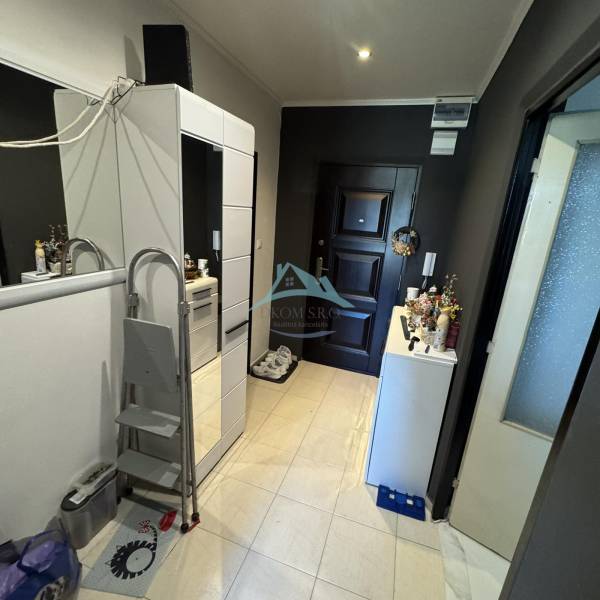 An entrance hall with a wardrobe and neutral colors in a 2-room apartment.