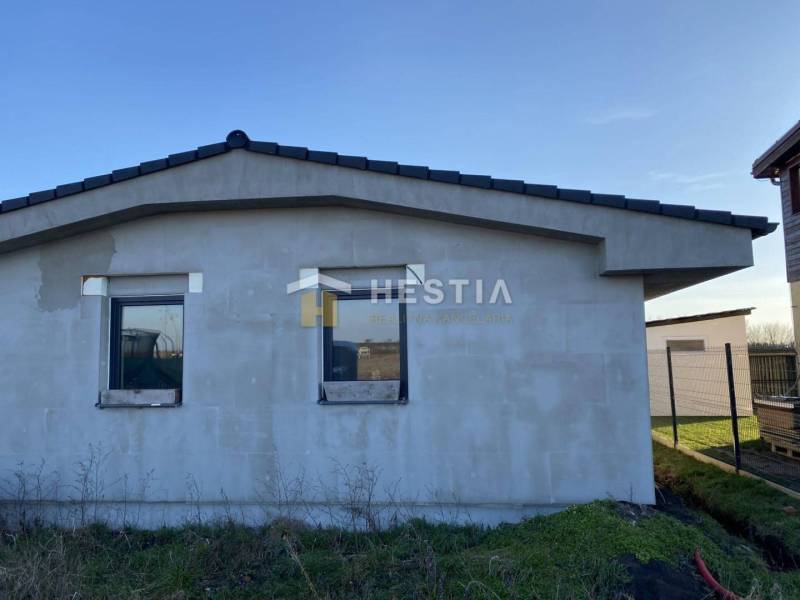 A family house in Sekule with an unfinished facade, flat roof, two windows.