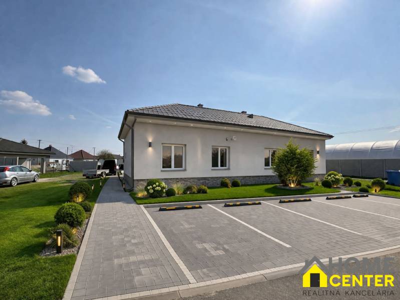 A family house in Zemianska Olča with a garden, parking, and a paved walkway.