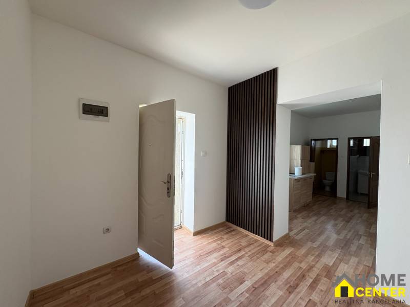 A family house with white walls and a wooden decor floor, spacious entrance area.