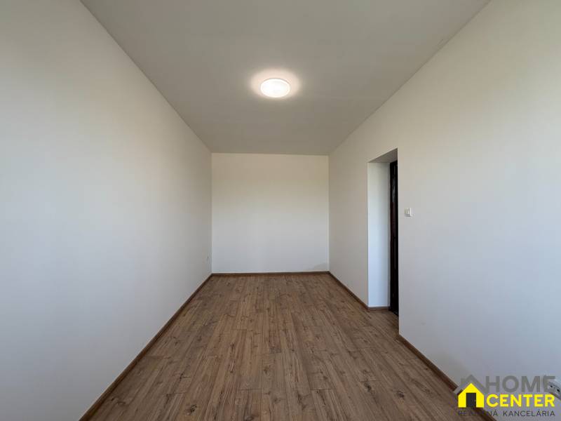 A family house with white walls and a wooden decor floor.