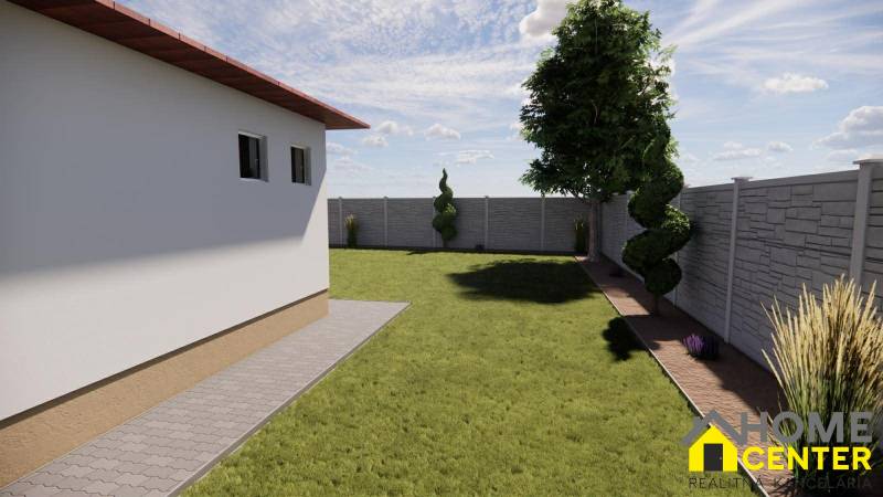 A garden at a family house in Zemianska Olča with a lawn and ornamental shrubs, surrounded by a fence.