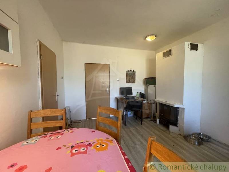 A dining room in a family house with a wooden table and a wooden decor floor.