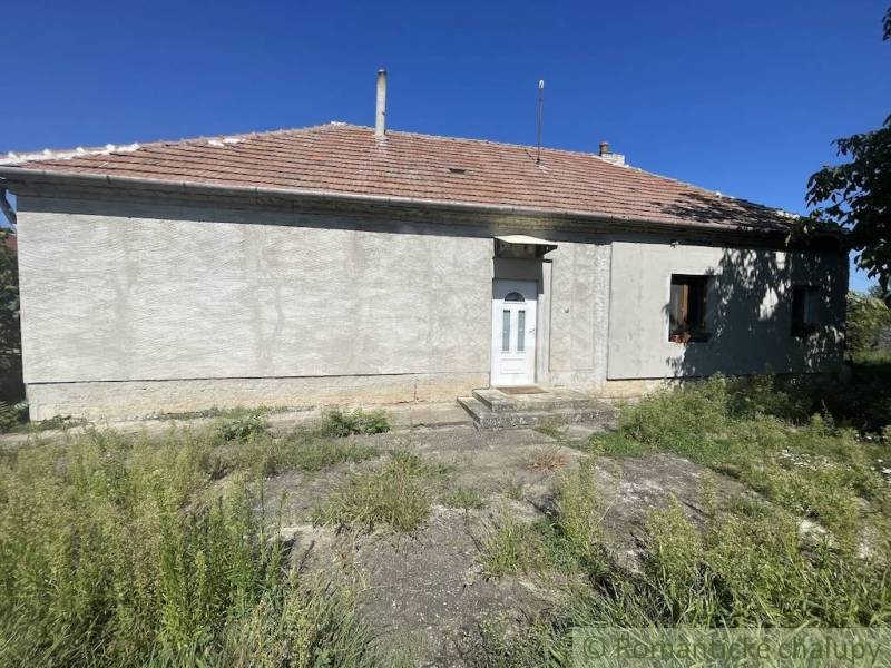 A family house in Jatov with a simple facade and surrounding greenery.