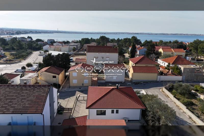 Aerial view of family houses on Mulo Street in Vrsi with a sea view.