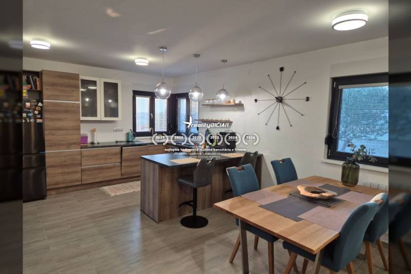 Family house kitchen with wood-patterned flooring, table, and tableware.