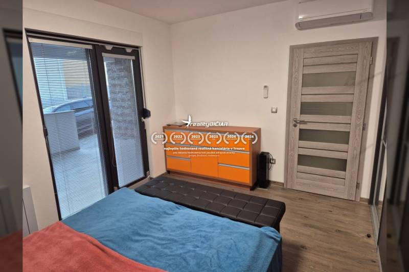 Bedroom in a family house with a bed, wardrobe, and floor with wooden decor.
