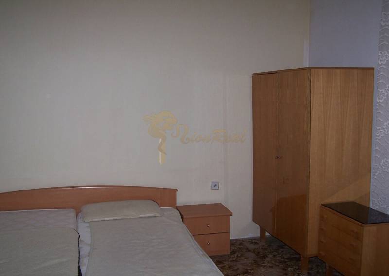 A bedroom in a 2-room apartment with simple furniture and a double bed.