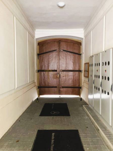 A corridor with large wooden doors and security lockers in Bratislava on Konventná.