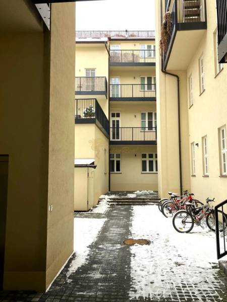 A courtyard with bicycles and snow-covered paving, Bratislava - Old Town, Konventná.