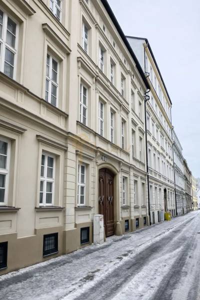 Snow-covered Konventná Street, Bratislava - Old Town, with ancient building facades.