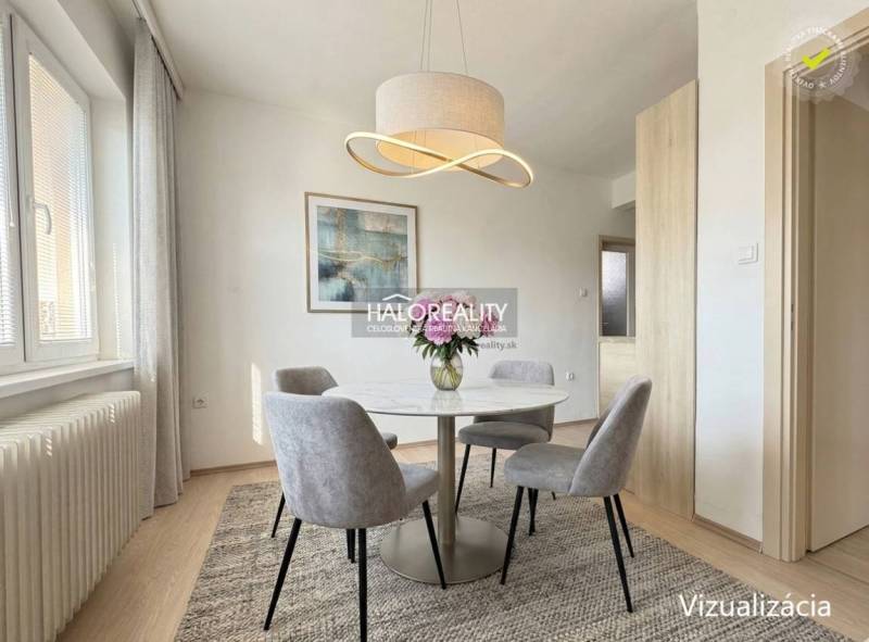 Dining area in a family house with a round table and an elegant light fixture.