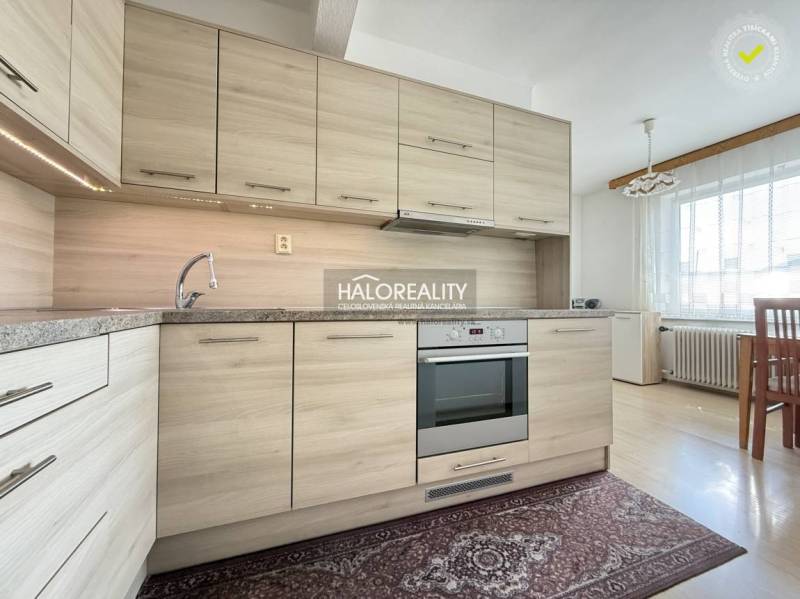 A kitchen in a family house with a wooden decor floor and a modern kitchen unit.