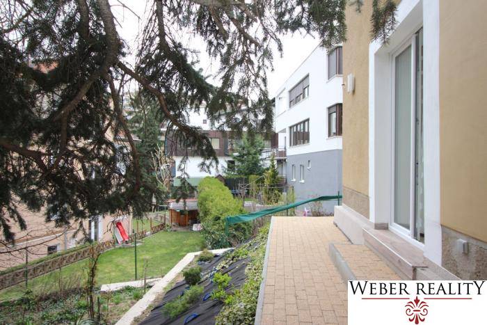 Garden space of a 1-room apartment on Lichardova Street in Bratislava, Old Town, with a terrace and plants.