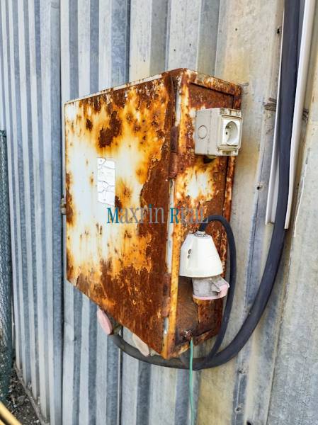 Rusty metal cabinet with electrical installation on the facade in Nitra. Land - commercial.