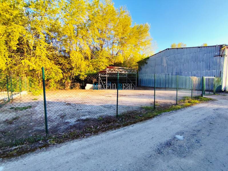 Lands - commercial in Nitra, fenced area with surroundings covered by trees.