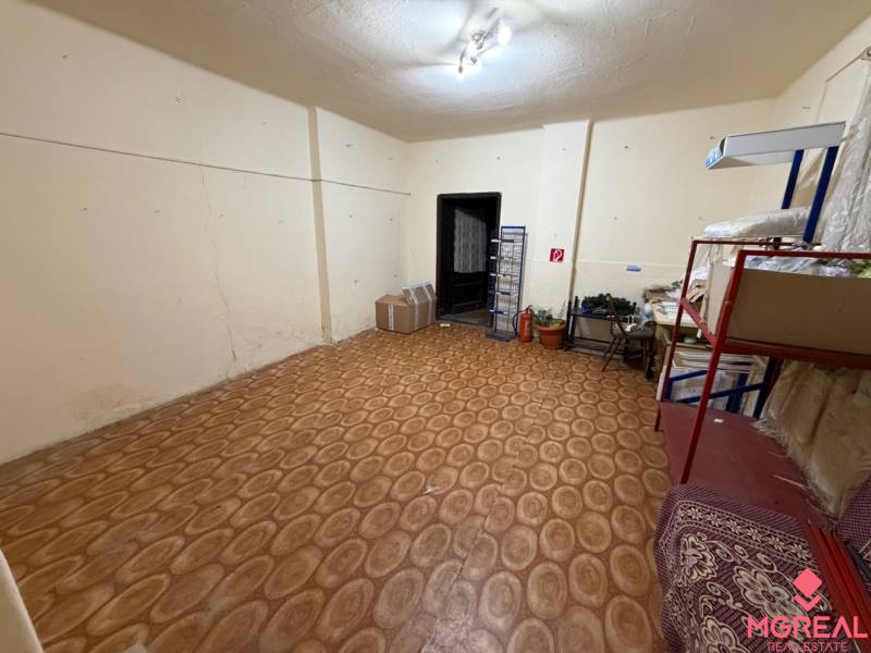 Room in a family house with shelves, boxes, and a wooden decor floor.