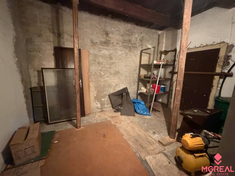 Storage space in a family house with shelves and randomly placed items.