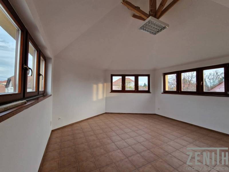 Interior of commercial spaces with tiling and large windows, providing plenty of natural light.