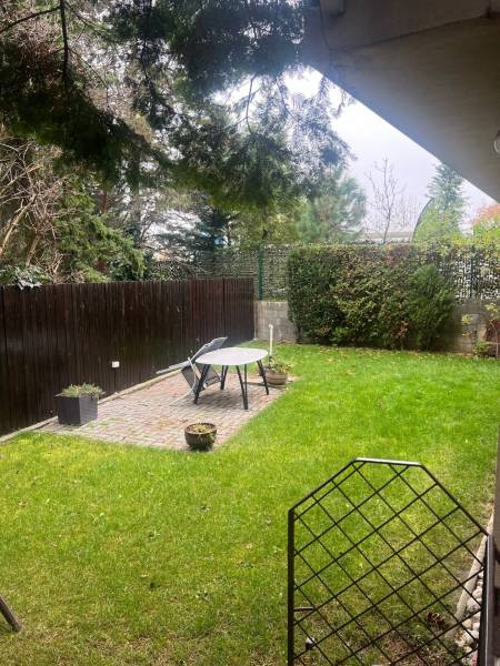 The garden of a family house on Mozartova Street in Bratislava - Staré Mesto with a lawn and a terrace.