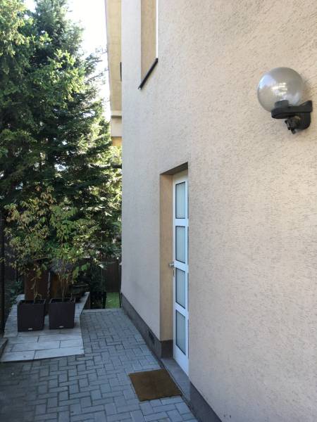 A family house on Mozartova Street in Bratislava - Staré Mesto with a paved walkway and greenery.
