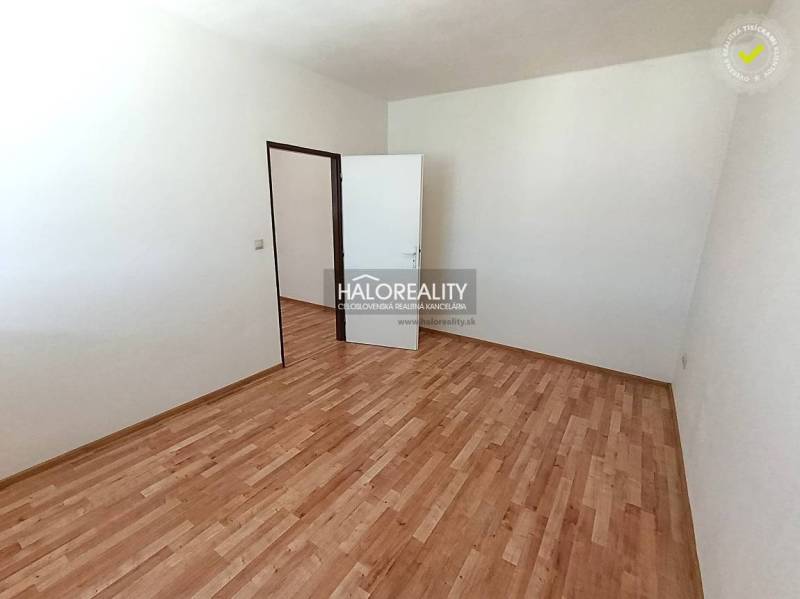 An empty room with a wooden decor floor in a 2-room apartment.