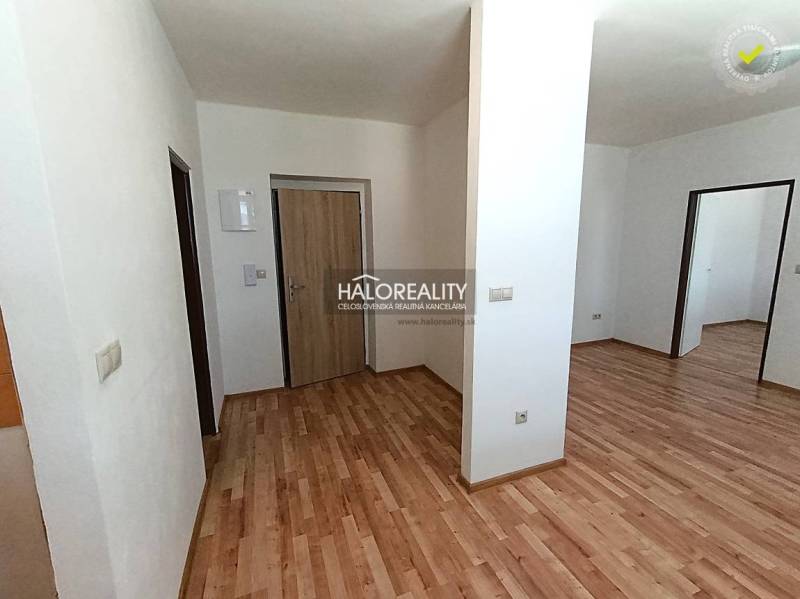 Interior of a 2-room apartment with a wooden decor floor and white walls.