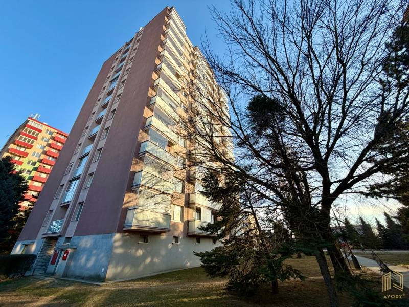 An apartment building on Štefánikova Street in Senica, surrounded by trees and lawn.