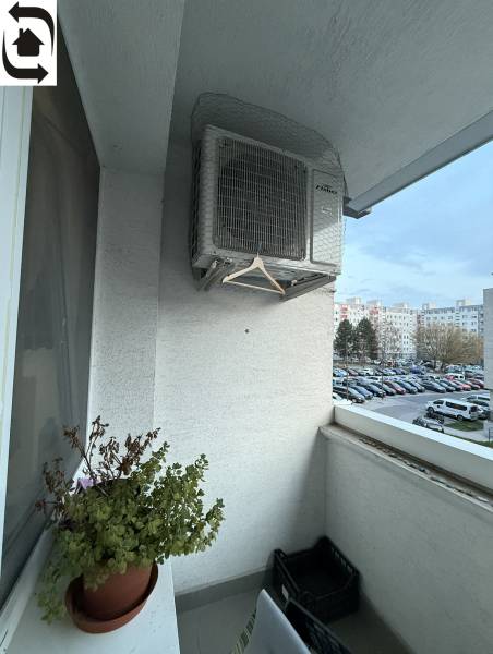 Balcony of a 4-room apartment on Kríkova Street, Bratislava - Vrakuňa with a flower pot and air conditioning.