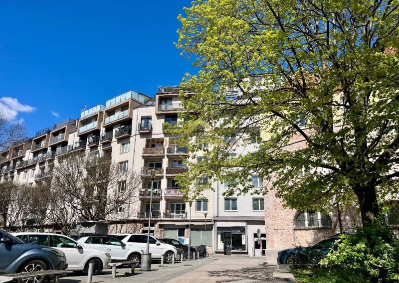 Apartment building on Dulovo Square in Bratislava - Ružinov with trees and parked cars.
