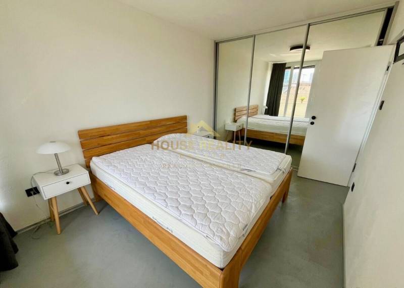 3-room apartment with a bed, wardrobe, nightstand, and mirrored doors.