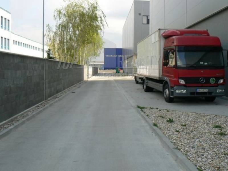 On Stará Vajnorská Street, a red truck near the warehouse halls.
