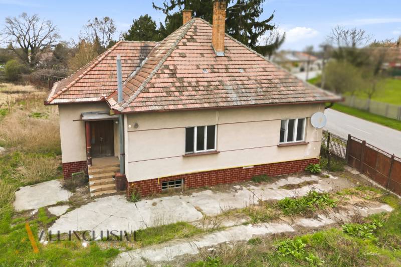 A family house in Michal na Ostrove with a sloped roof and a satellite dish.