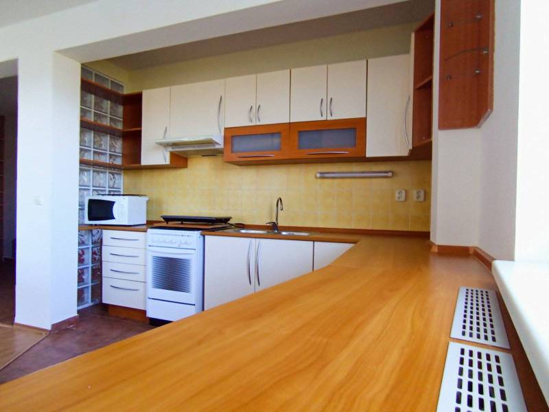 Kitchen in a 3-room apartment, front view, kitchen unit with wooden decor.