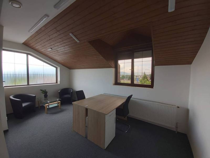 Offices with wood-patterned flooring, a desk, and carpets.