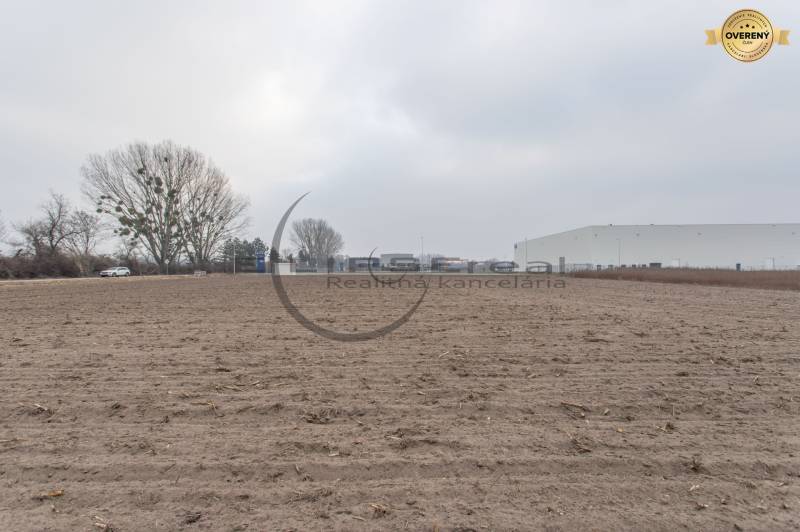 Commercial land on Priemyselná Street in Zohor with a building in the background.