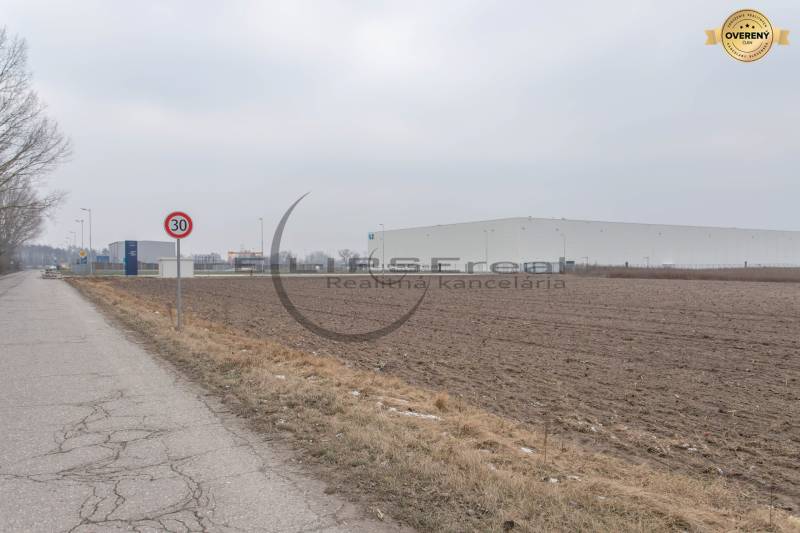Industrial Street in Zohor with a view of commercial plots and industrial buildings.