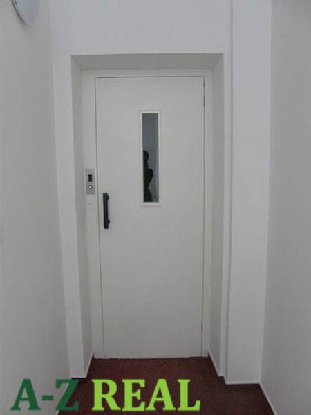 White door in the office with texture and label A-Z Real.