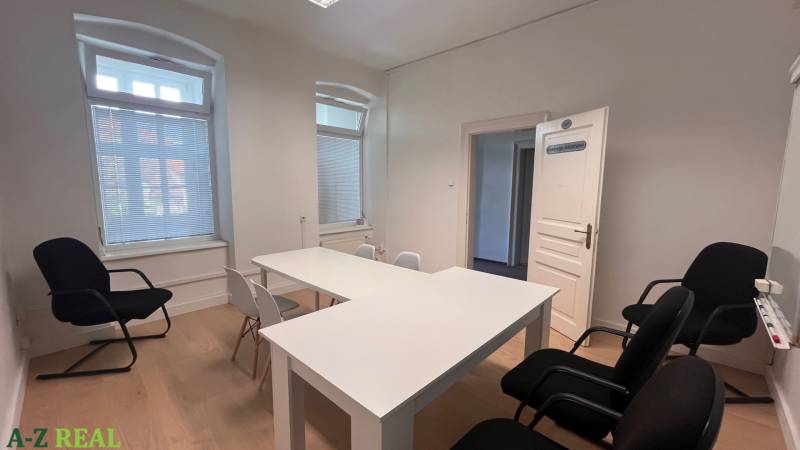 Offices with white desks and chairs, floor with wooden decor.