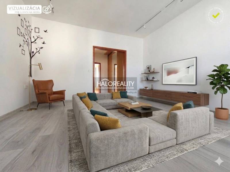 A cozy living room with wood-patterned flooring in a three-room apartment.