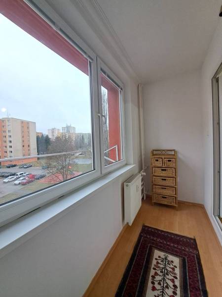A glazed balcony in a 2-room apartment with a view of the housing estate in Poprad.